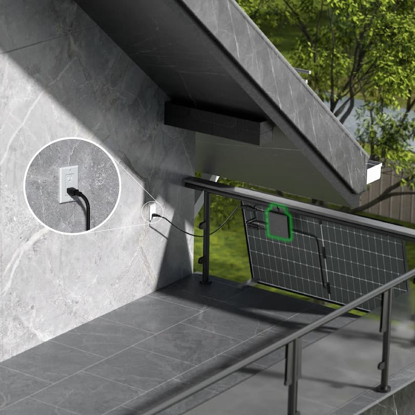 A plug-in solar panel hanging on a balcony railing
